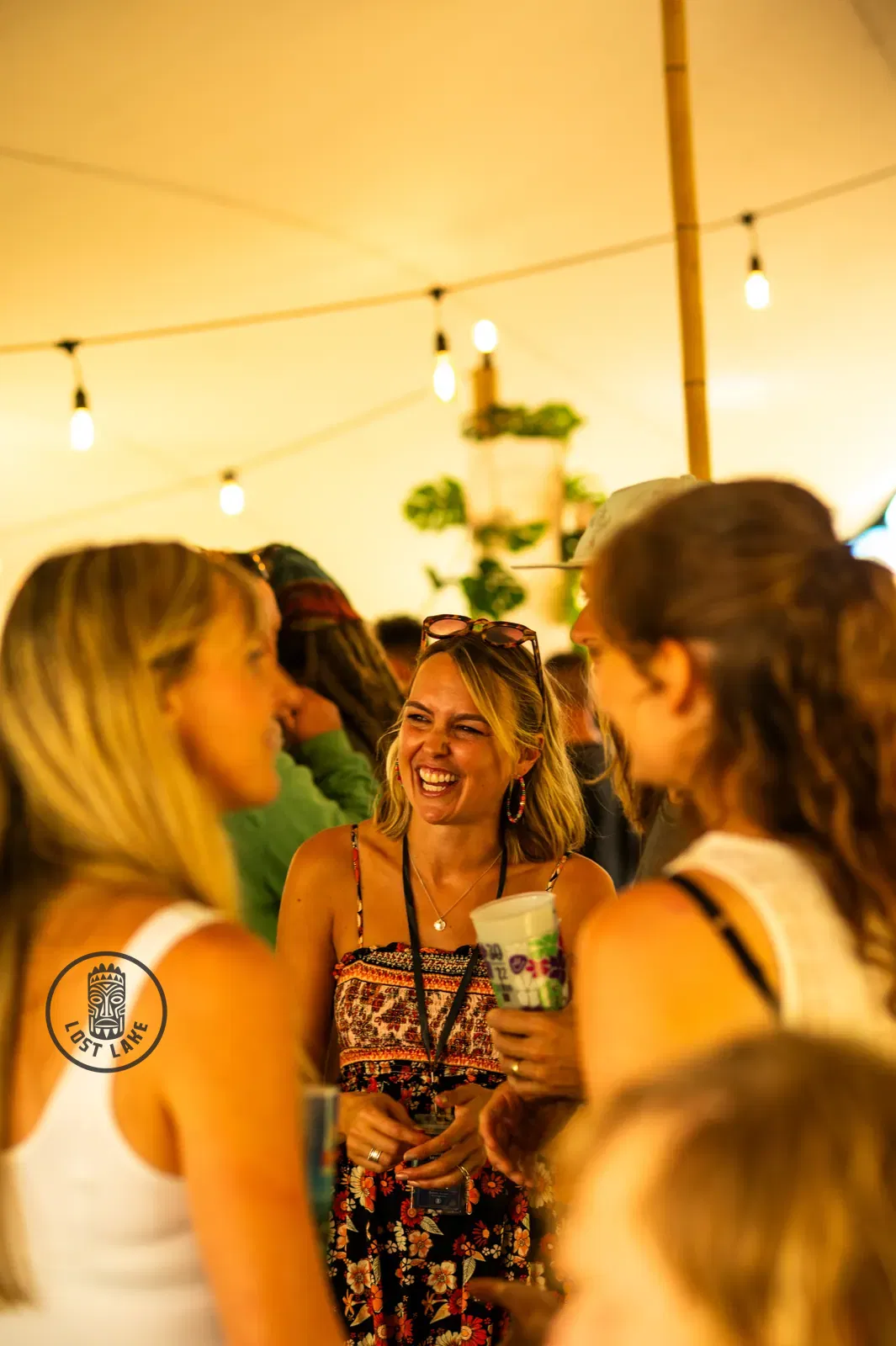 Guests laughing under the stretch tent at Lost Lake