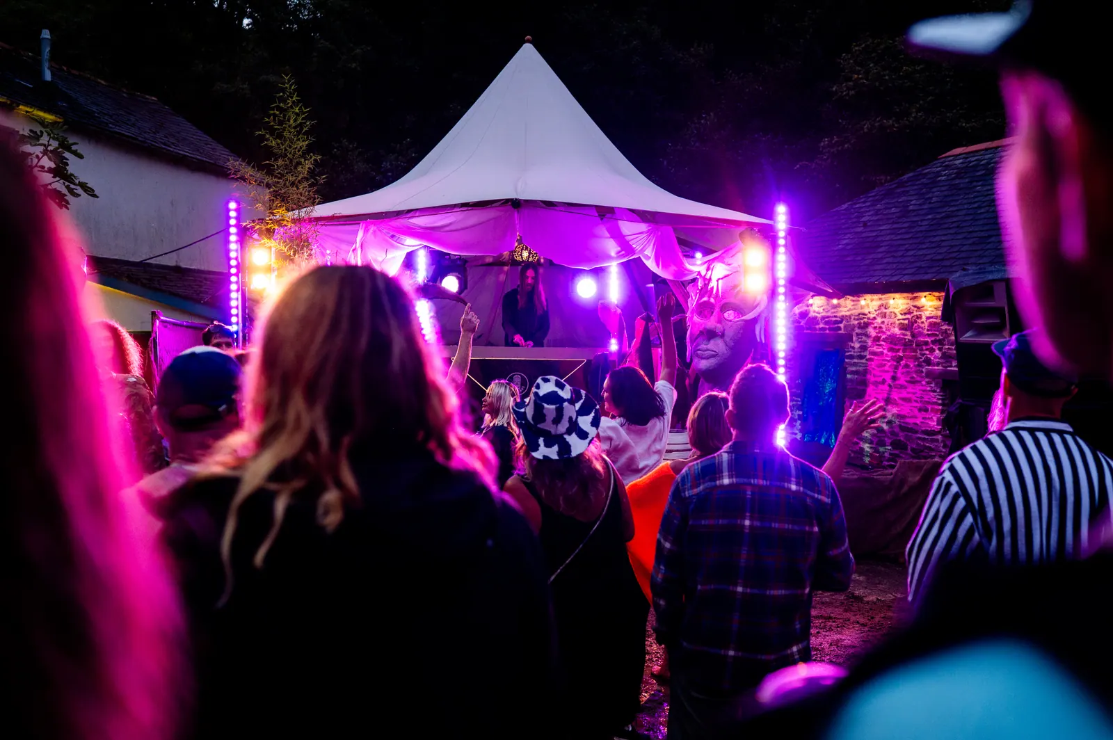 DJ booth under the white tent at night