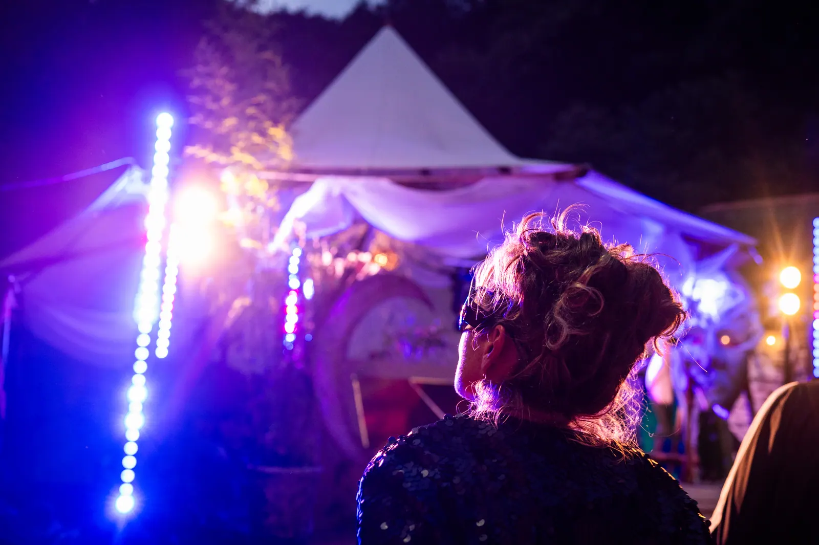 Moon arch and tent lights through the crowd
