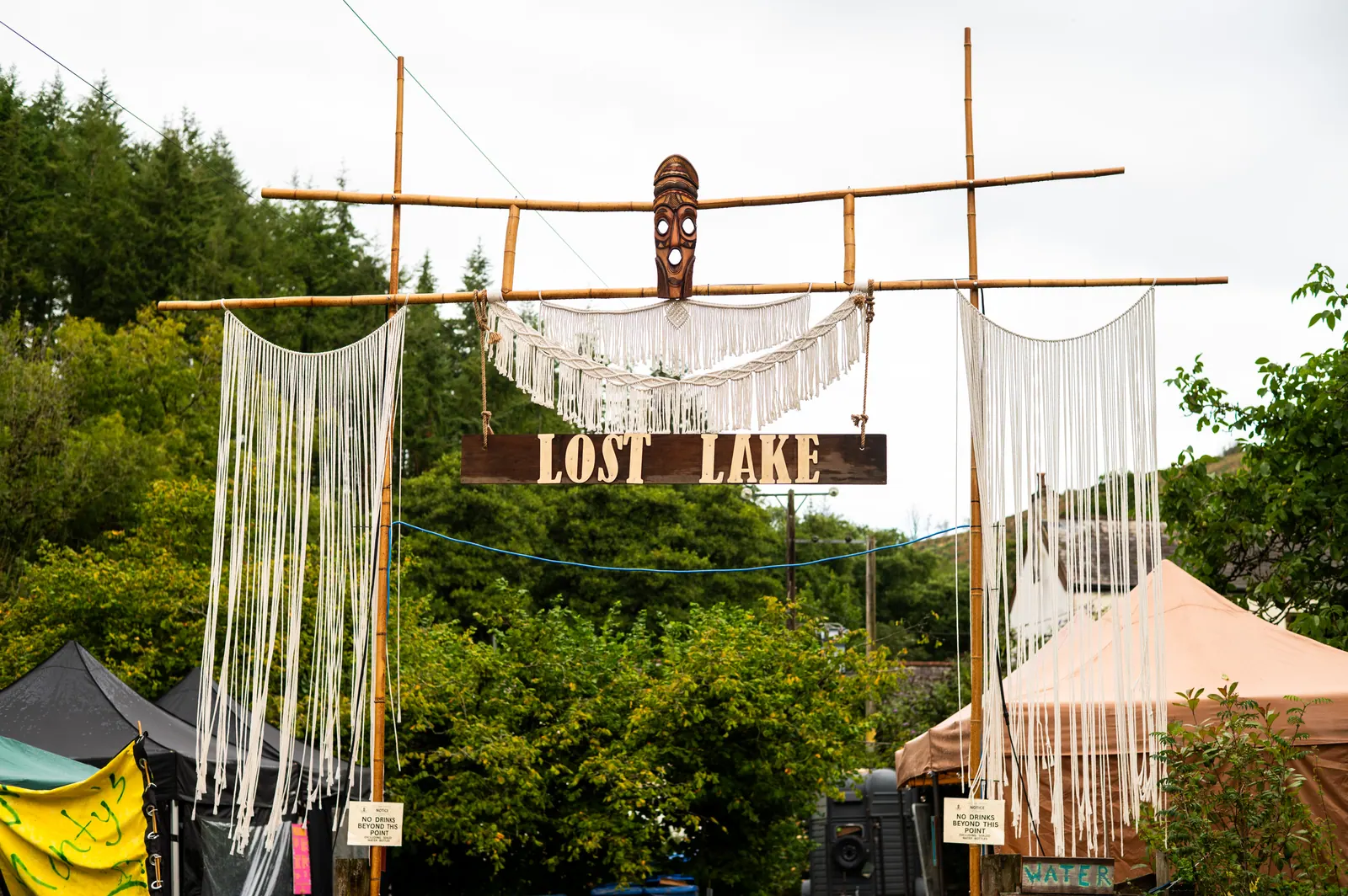 Lost Lake gate with carved mask and macramé