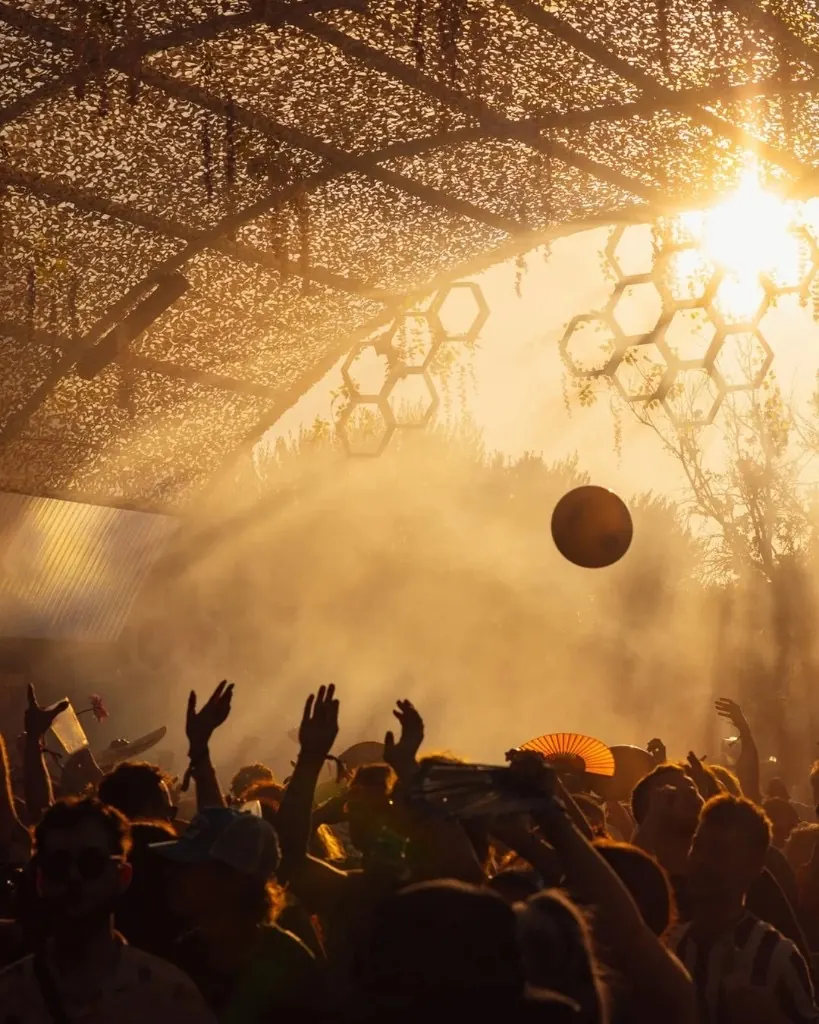 Golden sunrise over the mill and festival crowd